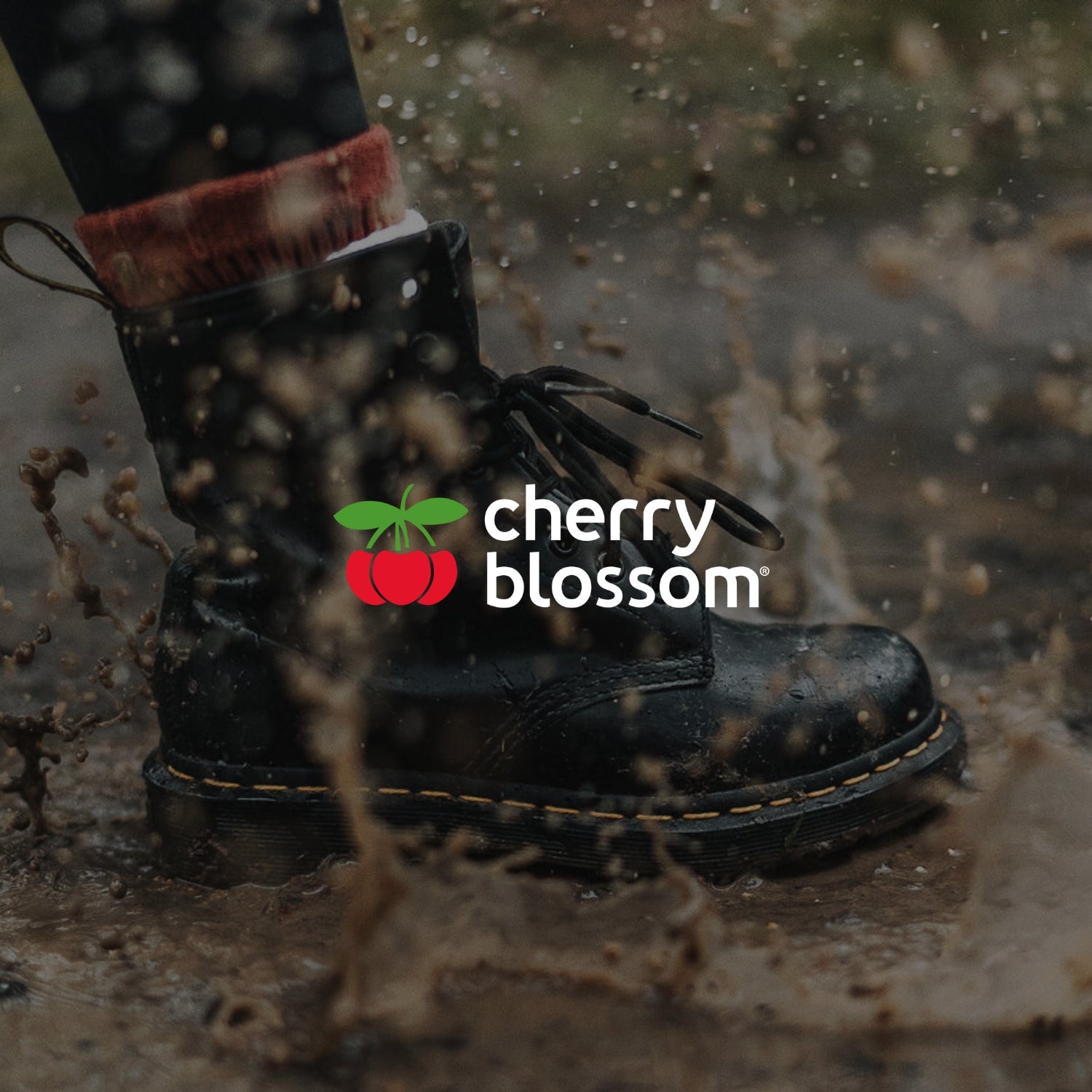 cherry blossom portfolio image with logo and boot in splashing in muddy puddle